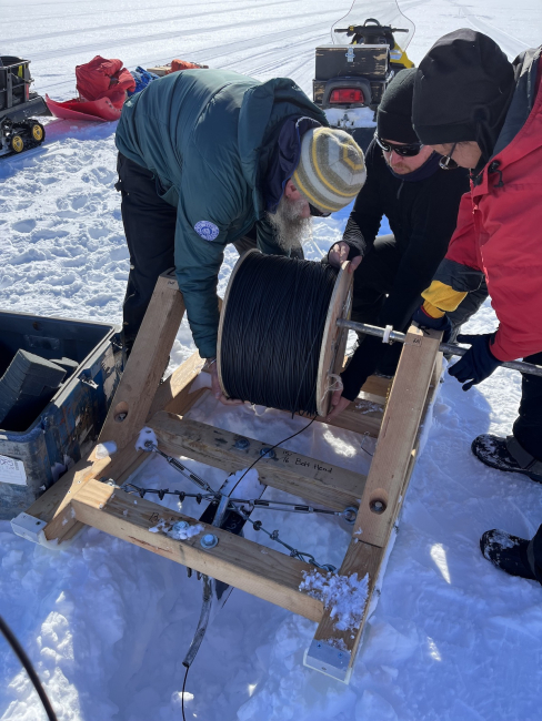 TIME team members Chris Simmons, Andrew Pretorius, and Yeshey Seldon test equipment near McMurdo Station in December 2023. Photo credit: Marianne Karplus