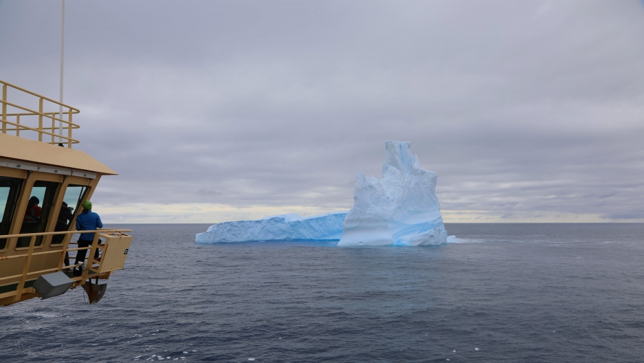 Researchers aboard the Nathanial B. Palmer gather on the ship’s bridge to view one of the first icebergs they encountered on their voyage to Antarctica.