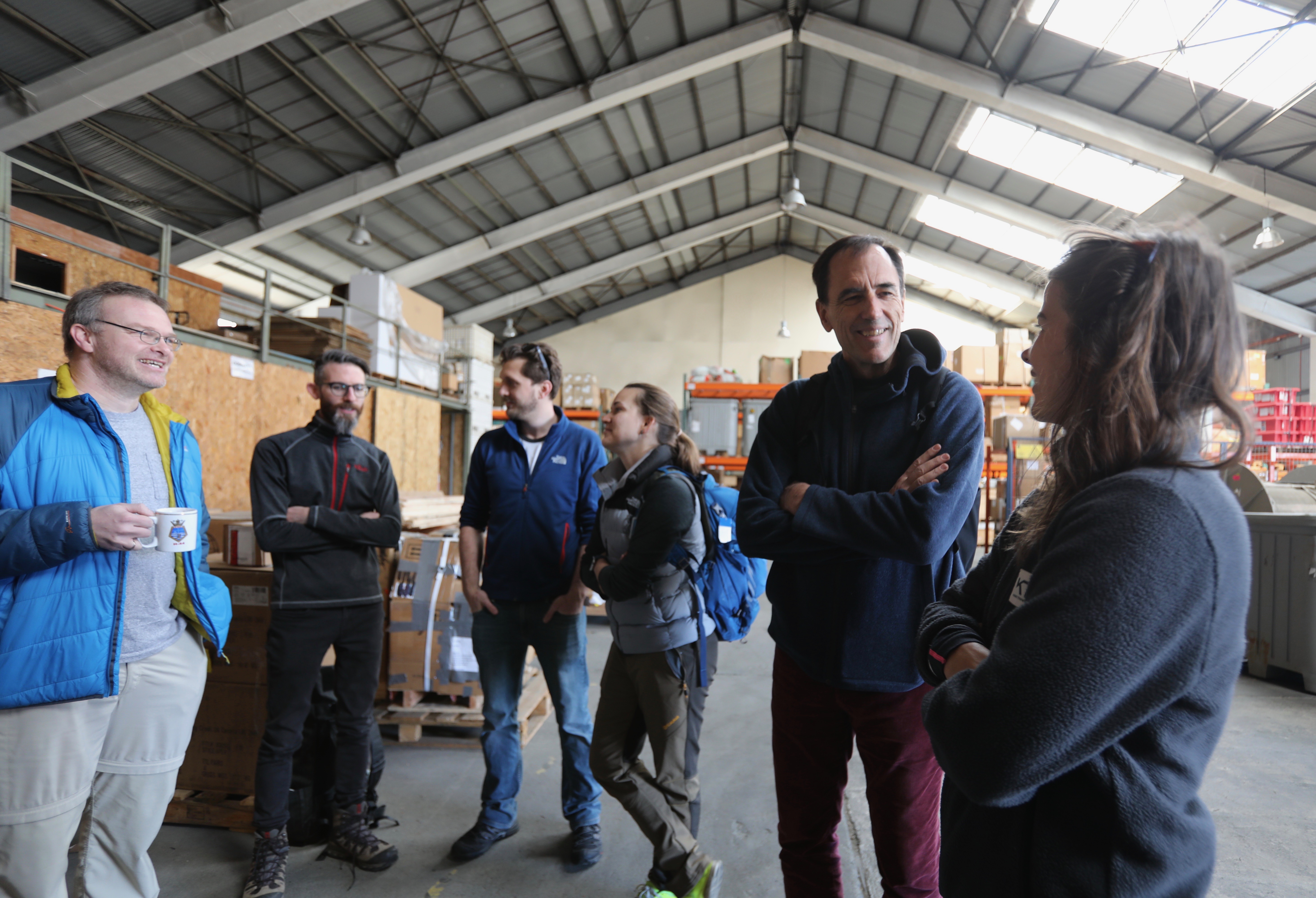 Participants at the warehouse near the ship.