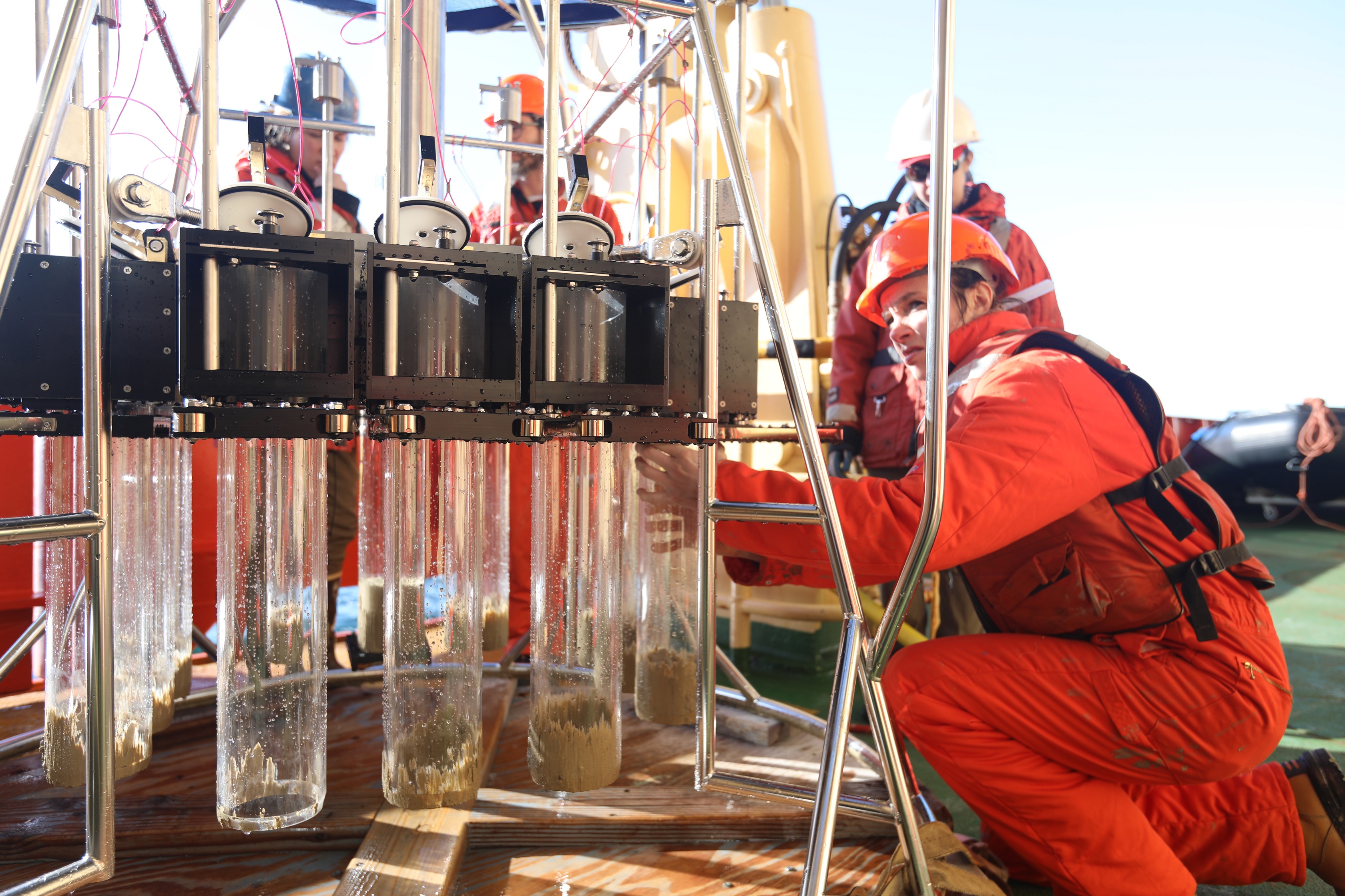Researchers prepare the corer for sediment collection. Credit Linda Welzenbach