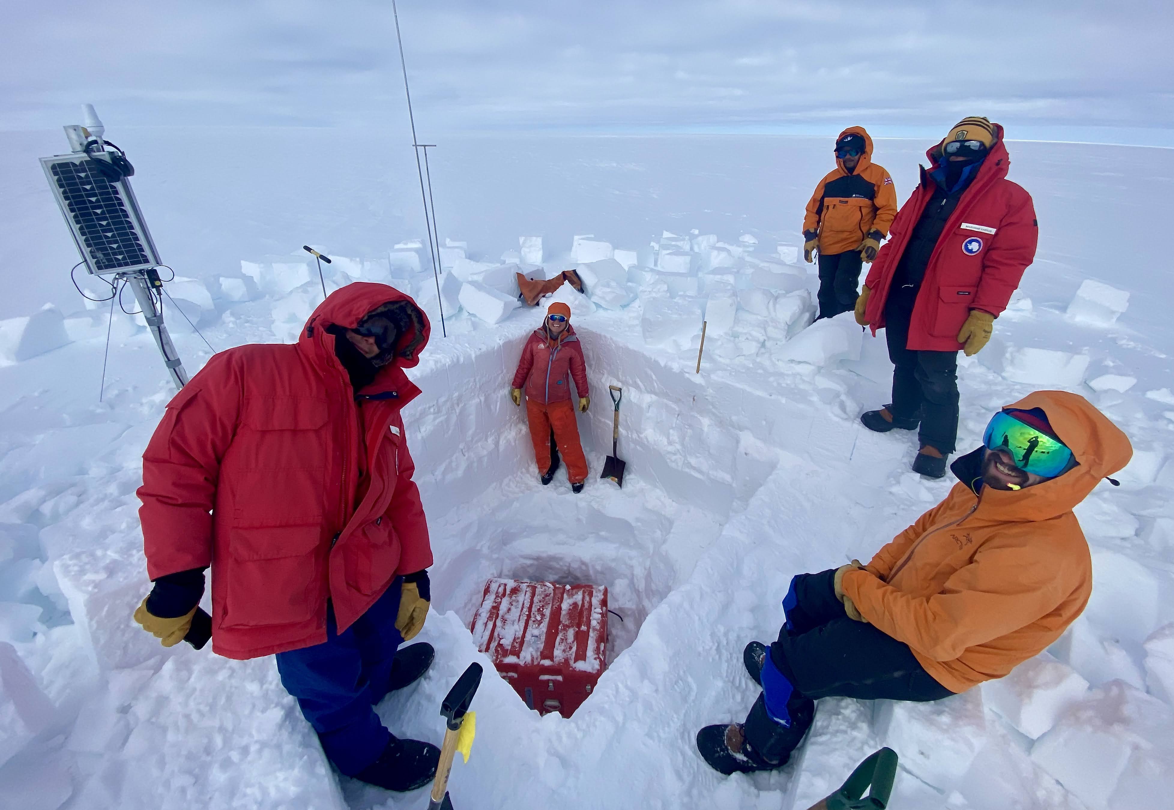 Figure 4. Five TIME team members with an excavated seismic enclosure containing the seismic data, batteries, power controllers, and other electronics. Photo by Mike Roberts.