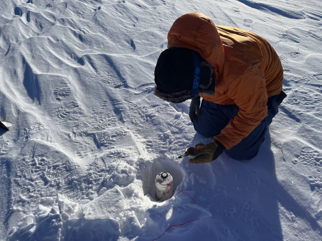 A researcher prepares a seismic node for deployment at Thwaites Glacier. Photo credit: Marianne Karplus