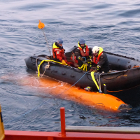 After the Hugin's first test in Antarctica, Jennie Mowatt, Filip Stedt, and Jonas Andersson (from left to right) have just wrangled the Hugin into its harness and now tow it over to the Palmer to be retrieved by the crane. Photo credit: Tasha Snow