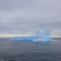 Researchers aboard the Nathanial B. Palmer gather on the ship’s bridge to view one of the first icebergs they encountered on their voyage to Antarctica.