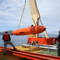 Crew raise the HUGIN autonomous underwater vehicle onto the desk of the N. B. Palmer after a successful deployment. Photo credit: Linda Welzenbach 