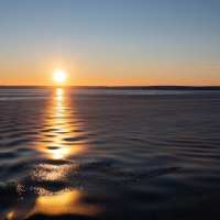 Grease ice dampens ripples in the water near sunset over the Amundsen Sea. Photo credit: Carolyn Beeler/The World