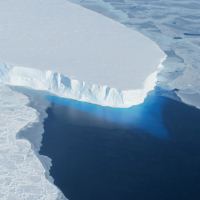 An ice cliff above the ocean adjacent to Thwaites Glacier in West Antarctica. Credits: NASA Public domain, via Wikimedia Commons.