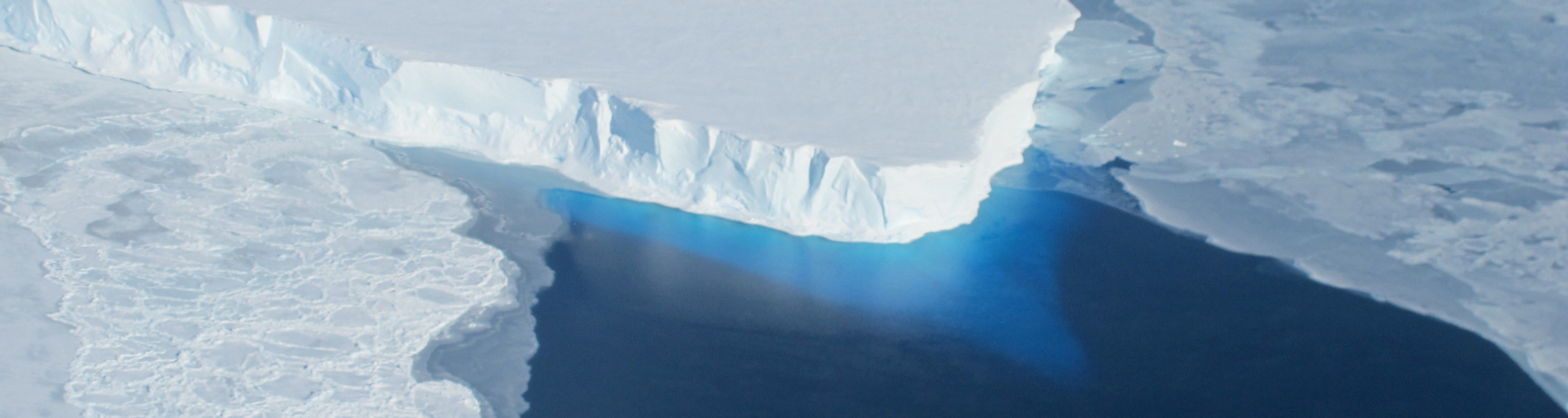 An ice cliff above the ocean adjacent to Thwaites Glacier in West Antarctica. Credits: NASA Public domain, via Wikimedia Commons.