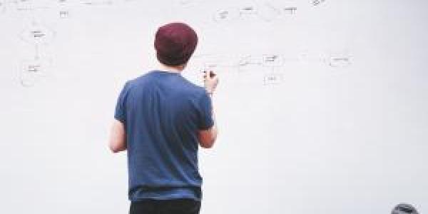 Man writing on white board